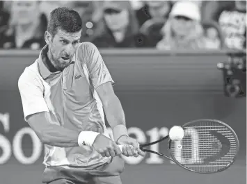  ?? KATIE STRATMAN/USA TODAY SPORTS ?? Novak Djokovic returns a shot against Taylor Fritz during the Western and Southern Open on Friday at Lindner Family Tennis Center in Mason, Ohio.