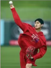  ?? BEN MARGOT — THE ASSOCIATED PRESS ?? The Angels’ Shohei Ohtani throws during a workout Tuesday in Tempe, Ariz.