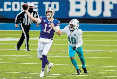  ?? JOHN MUNSON THE ASSOCIATED PRESS ?? Buffalo quarterbac­k Josh Allen, left, throws one of his three touchdown passes to wide receiver John Brown as the Bills won 56-26.