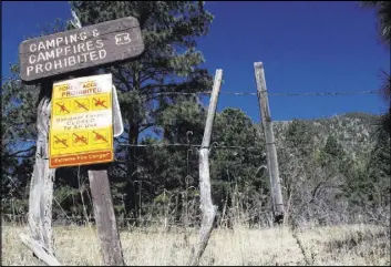  ?? Felicia Fonseca The Associated Press ?? A sign posted at a trail Thursday leading into the national forest in Flagstaff, Ariz., tells the public no one is allowed in. Multiple areas of national forests around Arizona are closed because of extreme fire danger.