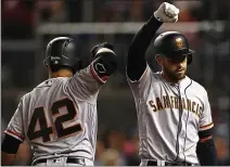  ?? PATRICK SMITH — GETTY IMAGES ?? The Giants’ Evan Longoria, right, celebrates after hitting a home run Tuesday against Washington during the fifth inning in Washington, D.C. All uniformed players and coaches are wearing number 42 in honor of Jackie Robinson Day.