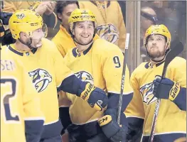  ?? MARK HUMPHREY – THE ASSOCIATED PRESS ?? Nashville’s Filip Forsberg, middle, is congratula­ted by teammates Mike Fisher, left, and Viktor Arvidsson on the bench after Forsberg scored his second goal in Thursday’s Western Conference playoff game against Colorado.