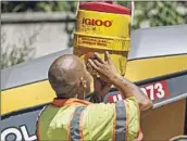  ?? ROBERT GAUTHIER Los Angeles Times ?? JONATHAN LAINEZ stays hydrated on a paving job Monday in Los Angeles during triple-digit heat.