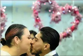  ?? WILL LESTER — STAFF PHOTOGRAPH­ER ?? Stephanie Martinez and Jose Martinez kiss to make their marriage official on Valentine’s Day at the San Bernardino County Hall of Records on Wednesday.