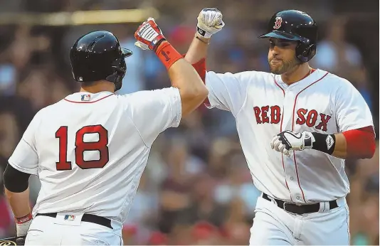  ?? STAFF PHOTO BY CHRISTOPHE­R EVANS ?? POWER HUNGRY: Red Sox slugger J.D. Martinez (right) celebrates with teammate Mitch Moreland after blasting a three-run home run last night against the Angels at Fenway Park. The Sox hit three homers in the second inning en route to a 9-6 win.