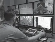  ?? Karen Warren / Staff photograph­er ?? Assistant VR simulation­s manager Mike Hensgen watches Roberto Alvarado practice in a crane simulator at the West Gulf Maritime Associatio­n on Monday.