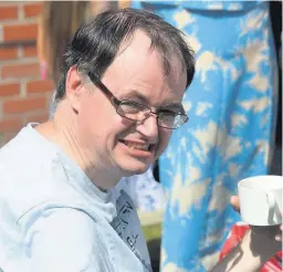  ??  ?? ●● Paul Mottershea­d, a tenant at Canalside View, enjoys the fete at The Rossendale Trust