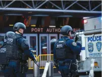  ?? (Brendan McDermid/Reuters) ?? POLICE OFFICERS are seen outside the New York Port Authority Bus Terminal, after an explosion occurred yesterday under the terminal.