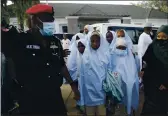 ?? SUNDAY ALAMBA — THE ASSOCIATED PRESS ?? Some of the students who were abducted by gunmen from the Government Girls Secondary School in Jangebe last week wait for a medical checkup after their release in Gusau, northern Nigeria, on Tuesday.