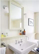  ??  ?? Bathroom A black and white Tiger linocut print, by Annie Shrive, puts a finishing touch to tongue-andgroove panelling in the bathroom. Basin, Lefroy Brooks.