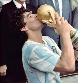  ??  ?? Diego Maradona kisses the World Cup trophy after Argentina’s 3-2 victory over West Germany in 1986, at the Azteca stadium, Mexico City.