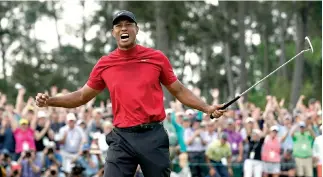  ?? AP Photo/David J. Phillip ?? ■ Tiger Woods yells in triumph after winning the Masters on Sunday in Augusta, Ga.