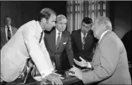  ?? IRA SCHWARZ-ASSOCIATED PRESS FILE PHOTO ?? FILE - In this July 13, 1982, file photo Secretary of State designate George Shultz, right, speaks with members of the Senate Foreign Relations Committee prior to the start of the afternoon session of the panel on Capitol Hill in Washington. From left. Sen. Joseph Biden, D-Del.; Sen. Charles Percy, R-Ill., chairman of the panel and Sen. Edward Zorinsky, D-Neb.