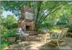  ?? ?? A flagstone patio and a fireplace add appeal to the fully fenced backyard.