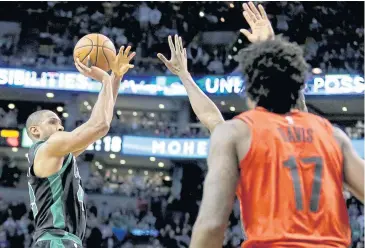  ?? AP ?? The Celtics’ Al Horford, left, launches the winning shot against Portland.