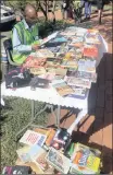  ??  ?? Thabo Mokwena selling books (and reading) at St Aidan’s Church.