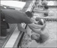  ?? The Associated Press ?? DEFYING ODDS: Jersey Hammerhead­s swimmer Michael McQuay and his father and coach Mike, during the filming of a documentar­y at a sectional swim meet for the Special Olympics in Neptune, N.J on April 26, 2016. Michael McQuay and his parents boldly defy...