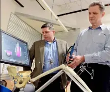 ?? Bob Donaldson/Post-Gazette ?? Mr. Markovitz, left, and Mr. Jaramaz give a demonstrat­ion of how their company’s surgical tool used in knee replacemen­t surgery works.