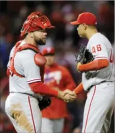  ?? BILL BOYCE — THE ASSOCIATED PRESS ?? The Phillies’ Cameron Rupp, left, and Jeanmar Gomez (46) celebrate their 1-0 victory over the Cardinals Tuesday in St. Louis.