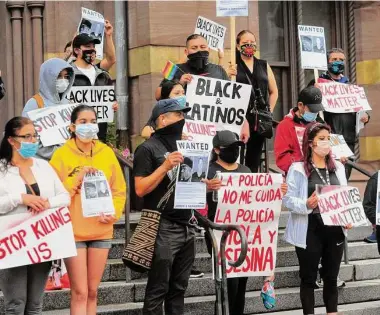  ?? Christian Abraham/Hearst Connecticu­t Media file photo ?? Over 50 people with Unidad Latina en Accion protest police brutality against Black people and Latinos at City Hall in New Haven on June 11, 2020. The silent march was held in solidarity with the Black Lives Matter movement in the aftermath of the death of George Floyd in police custody in Minneapoli­s.