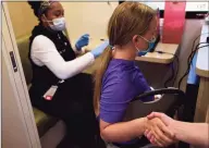  ?? Erik Trautmann / Hearst Connecticu­t Media ?? Ann Taylor gets vaccinated at a COVID vaccine clinic at West Rocks Elementary School in Norwalk on May 20.