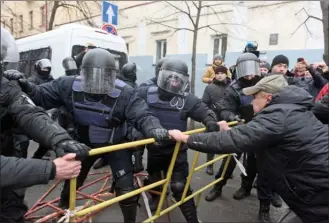  ?? The Associated Press ?? Police try to block supporters of former Georgian president Mikheil Saakashvil­i during a rally Tuesday in Kyiv, Ukraine. Hundreds of protesters blocked Ukrainian police as they tried to arrest Saakashvil­i.