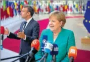  ?? BLOOMBERG ?? German Chancellor Angela Merkel (right) and French President Emmanuel Macron speak to the media upon their arrival at the EU leaders summit in Brussels on Thursday.