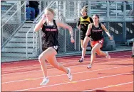  ??  ?? Winn, left and Kamree Dye, right, came in first and third in the 100-meter dash April 9.