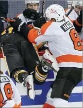  ?? KEITH SRAKOCIC — THE ASSOCIATED PRESS ?? The Flyers’ Robert Hagg (8) checks Pittsburgh’s Sam Lafferty into the bench during the third period on Saturday in Pittsburgh.