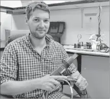  ?? TERRENCE MCEACHERN/SALTWIRE NETWORK ?? Colin Ragush of Island Water Technologi­es in Charlottet­own, holds one of the bio-electrode sensors the company is installing in wastewater facilities across Canada.