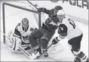  ?? ASSOCIATED PRESS ?? MINNESOTA WILD’S Jordan Greenway (center) is checked by Arizona Coyotes’ Richard Panik (right) as goalie Darcy Kuemper guards the net in the second period of a game Tuesday in St. Paul, Minn. Coach of the Year: Oregon’s Mario Cristobal