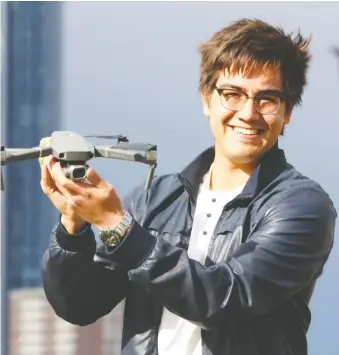  ?? BRENDAN MILLER ?? Videograph­er Eric Gonzalez displays the drone he used to take footage of Calgary’s empty streets and community places. He used the footage in a video he posted.