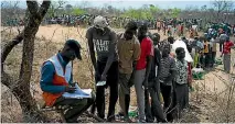  ?? GETTY IMAGES ?? Families are registered as they wait in line to receive aid from the World Food Programme at the Bidi Bidi refugee camp in Arua, Uganda, last week.