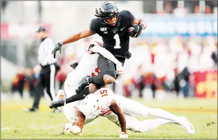  ??  ?? Iowa State wide receiver Tarique Milton (1) is tackled by Texas defenders D’Shawn Jamison (left), and Chris Brown after catching a pass during the first
half of an NCAA college football game on Nov 16 in Ames, Iowa. (AP)