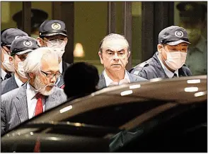  ?? Kyodo News via AP/KEISUKE KOITO ?? Former Nissan Chairman Carlos Ghosn (center) leaves a Tokyo jail Thursday. He has been detained twice since November.