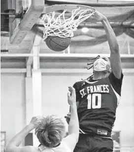  ?? KENNETH K. LAM/BALTIMORE SUN ?? St. Frances’ Julian Reese dunks over Loyola Blakefield’s Gavin Walsh during a game Monday night.