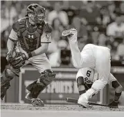  ?? Karen Warren / Houston Chronicle ?? Marwin Gonzalez takes a tumble while batting in the eighth inning Tuesday night, when the Astros squandered a bases-loaded opportunit­y.