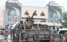  ?? — AFP ?? Soldiers stand in a military vehicle as they lead the procession to the cemetary for the burial of Kofi Annan on Thursday.