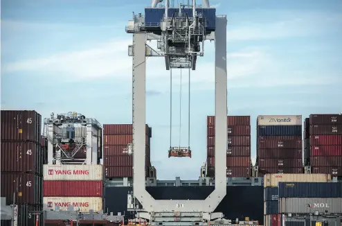  ?? STEPHEN B. MORTON / THE ASSOCIATED PRESS ?? A ship-to-shore crane prepares to load a 40-foot container onto a ship at the Port of Savannah in Georgia. In the U.S., there are severe restrictio­ns on vessels travelling from one U.S. port to another.