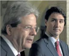  ?? ADRIAN WYLD/THE CANADIAN PRESS ?? Prime Minister Justin Trudeau, right, listens to Italian Prime Minister Paolo Gentiloni during a news conference on Parliament Hill, in Ottawa on Friday.