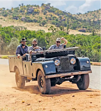  ?? ?? g‘Boy’s own fun’: safari camp co-owner Ed Hough, rear left, explores the terrain in a Series I Land Rover from 1957