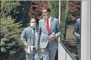  ?? CAROLYN COLE Los Angeles Times ?? JAMON HICKS, right, attorney for the family of Robert Fuller, walks to a news conference Friday.