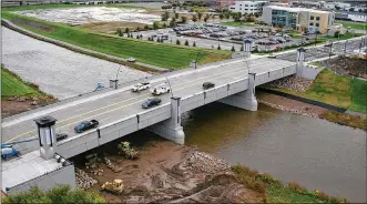  ?? TY GREENLEES / STAFF ?? The $11 million Webster Street Bridge project over the Mad River was completed Nov. 2. Here, contractor­s work to ready the concrete-spanned and lighted bridge days before the ribbon-cutting ceremony officially opening the bridge. The cost of the...