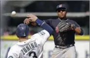  ?? ELAINE THOMPSON — THE ASSOCIATED PRESS ?? Indians second baseman Jose Ramirez throws to first base after forcing out the Mariners’ Mike Zunino on a double play in the third inning.