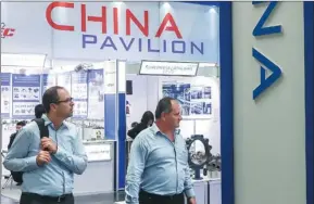  ?? SHAN YUQI / XINHUA ?? Left: Visitors attend China’s booth at Germany’s Hannover Messe last year.