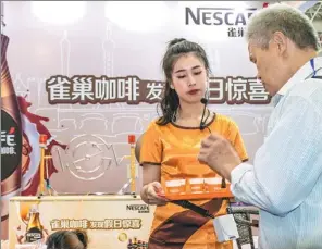  ?? PROVIDED TO CHINA DAILY ?? A man tries a Nestle coffee product at the 19th Cross-Straits Fair for Economy and Trade in Fuzhou, capital of East China’s Fujian province, on May 18, 2017.