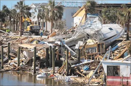  ?? Scott Olson Getty Images ?? DAMAGE from Hurricane Michael, which hit Florida in October. President Trump says he intends to sign the $19-billion disaster aid bill.