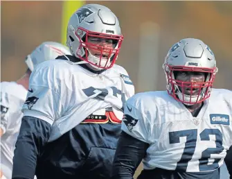  ?? NANCY LANE / BOSTON HERALD ?? QUIETLY PRODUCING BIG: Trent Brown (left) stands alongside fellow Patriots offensive tackle Eric Smith during practice yesterday at Gillette Stadium.