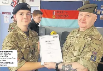  ??  ?? Well-deserved Cadet Ross Kay receives his commendati­on from battalion commandant Alex McNamee