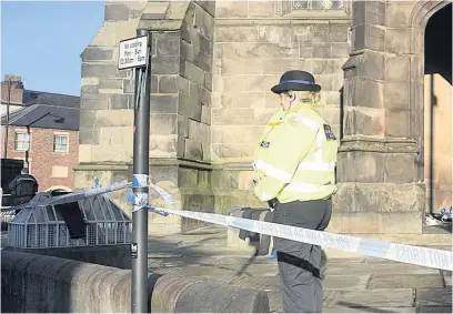  ?? Colin J. Horne ?? ●●A police officer outside St Mary’s Church in Stockport